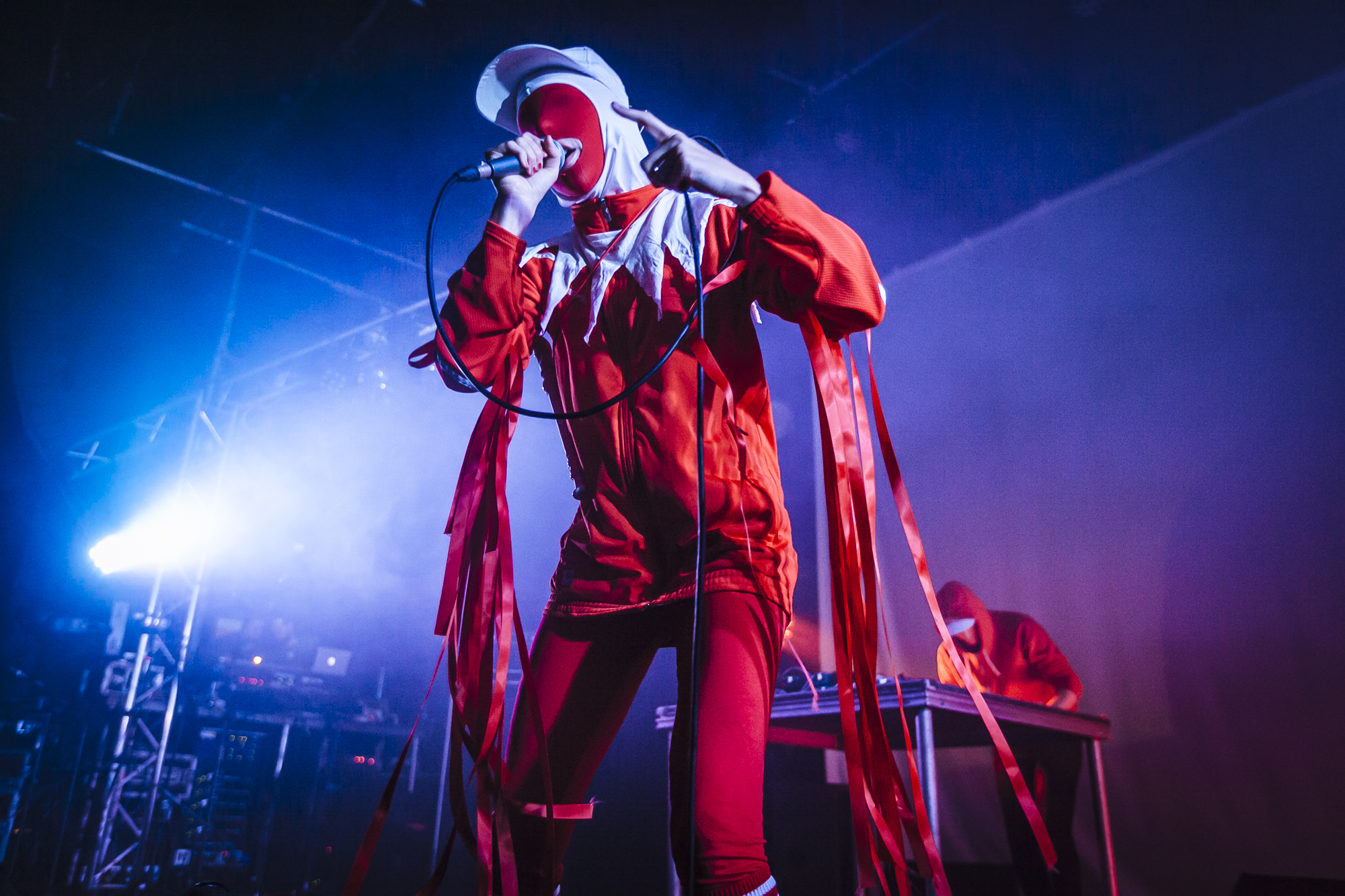 Gazelle Twin in Red Jester-style costume performing live at Supersonic 2018