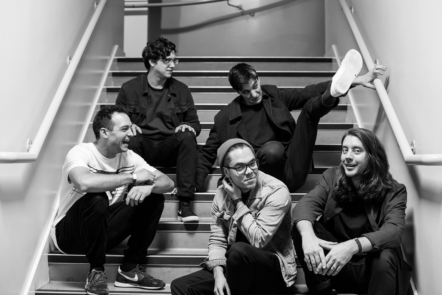 the band Hoopla Blue sit on steps outside their gig